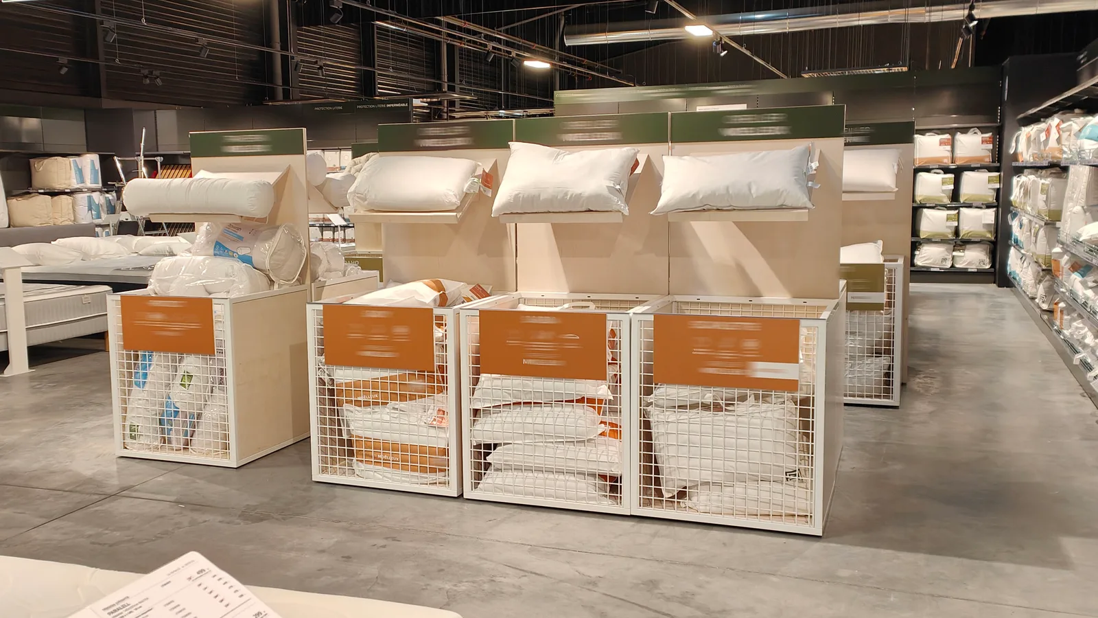 Mobilier de petite literie combinant oreillers exposés et rangement en paniers